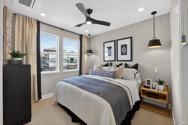 a bedroom with a large bed and a large window