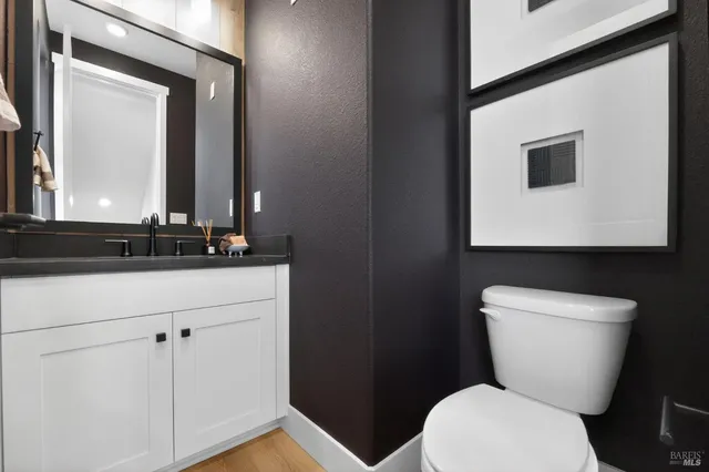 a bathroom with a toilet a sink and mirror