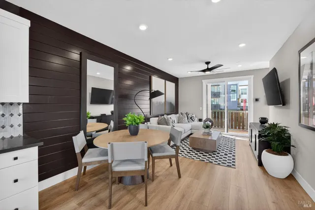a living room with furniture potted plant and a flat screen tv