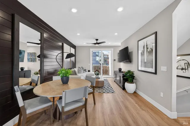 a view of a dining room with furniture and wooden floor