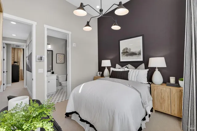 a bed room with a bed and a chandelier