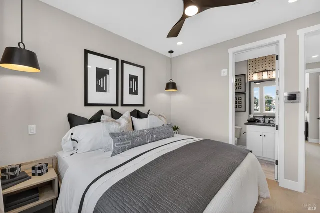 a bedroom with a bed and a chandelier