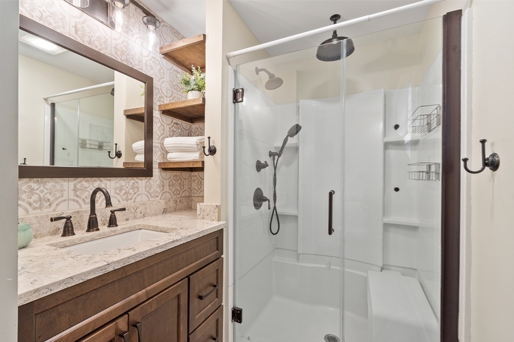 84 Constance Drive Lowell, MA 01854 - Photo 14 of 27 a bathroom with a shower sink and mirror