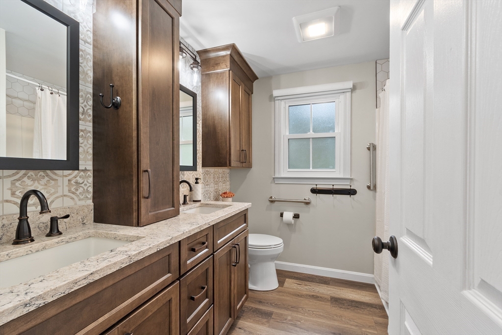 84 Constance Drive Lowell, MA 01854 - Photo 20 of 27 a bathroom with a granite countertop sink toilet and mirror