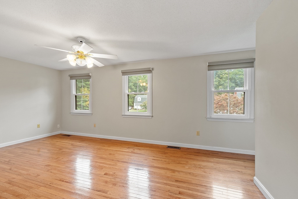 84 Constance Drive Lowell, MA 01854 - Photo 23 of 27 a view of an empty room with wooden floor and a window