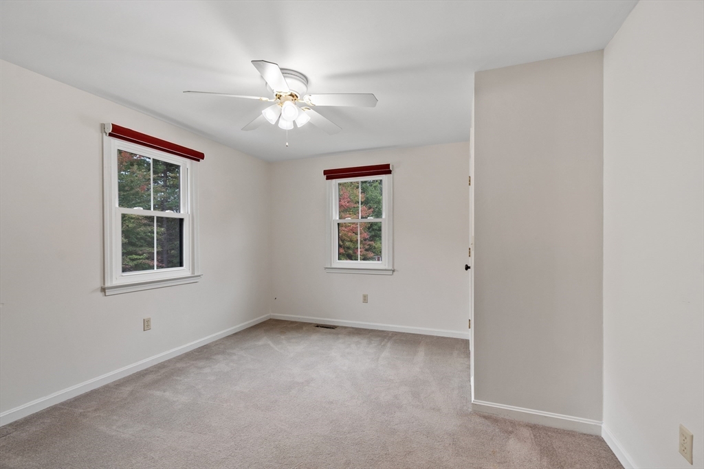 84 Constance Drive Lowell, MA 01854 - Photo 24 of 27 an empty room with windows and fan