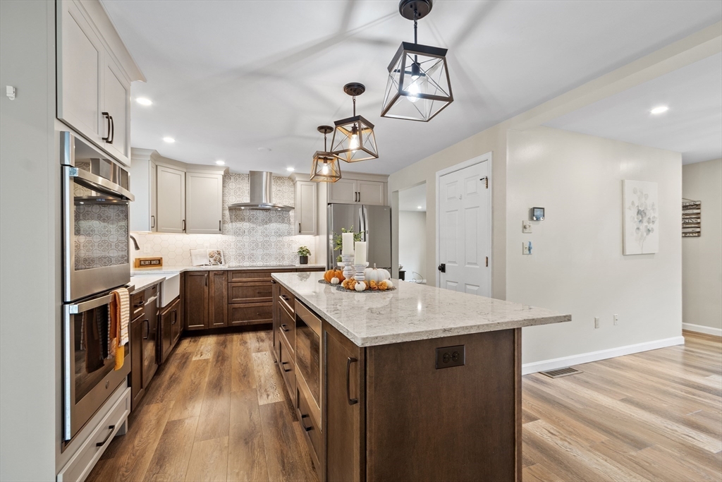 84 Constance Drive Lowell, MA 01854 - Photo 8 of 27 a kitchen with stainless steel appliances granite countertop a sink stove and refrigerator