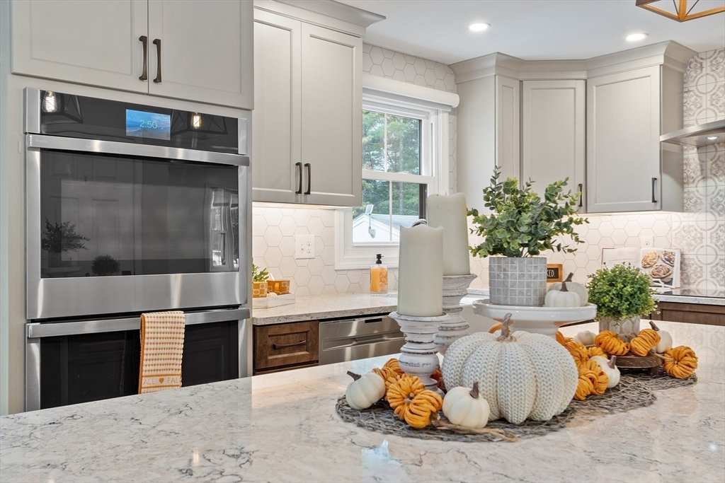 84 Constance Drive Lowell, MA 01854 - Photo 9 of 27 a living room with furniture and a fireplace