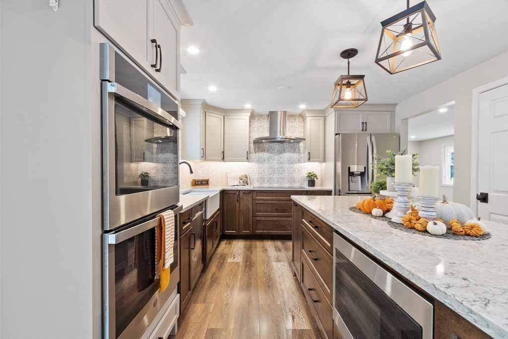 84 Constance Drive Lowell, MA 01854 - Photo 10 of 27 a kitchen with stainless steel appliances granite countertop counter space a sink and cabinets