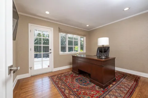 a view of a house with backyard sitting area and garden