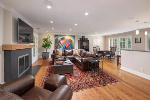 a kitchen with stainless steel appliances granite countertop a sink a stove and a refrigerator