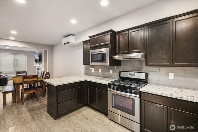a kitchen with granite countertop stainless steel appliances and wooden cabinets