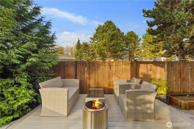 a view of backyard with swimming pool and sitting area