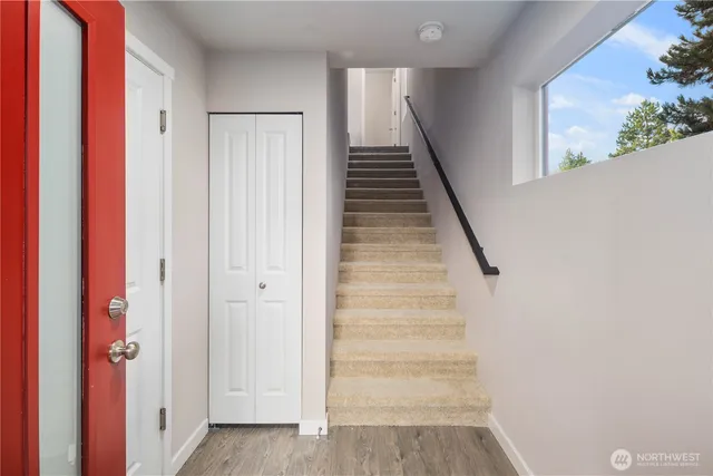 a view of entryway with stairs and wooden floor