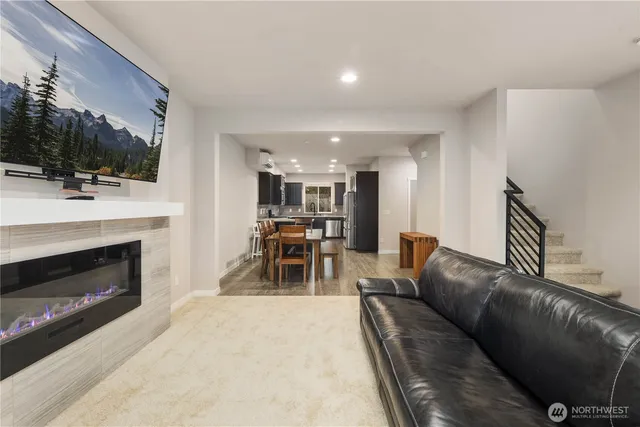 a living room with furniture a fireplace and a flat screen tv
