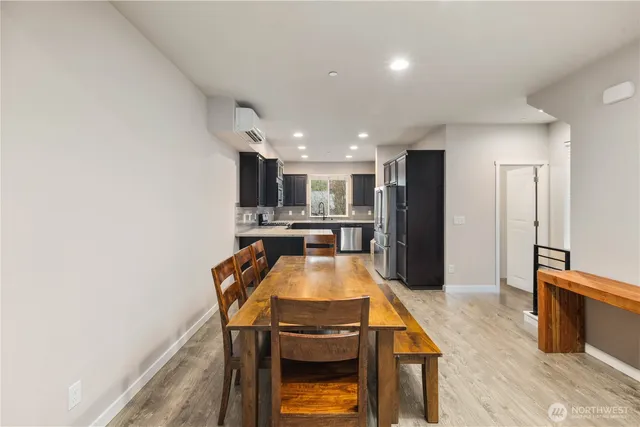 a kitchen with stainless steel appliances granite countertop a refrigerator a stove and a wooden cabinets