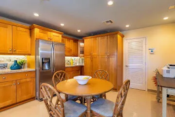 a kitchen with kitchen island a counter top space appliances and cabinets