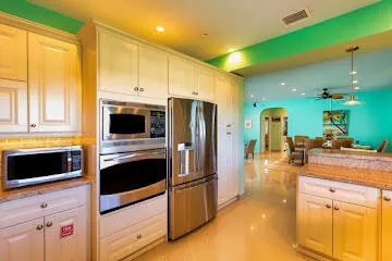 a view of a chairs and table in patio next to a yard