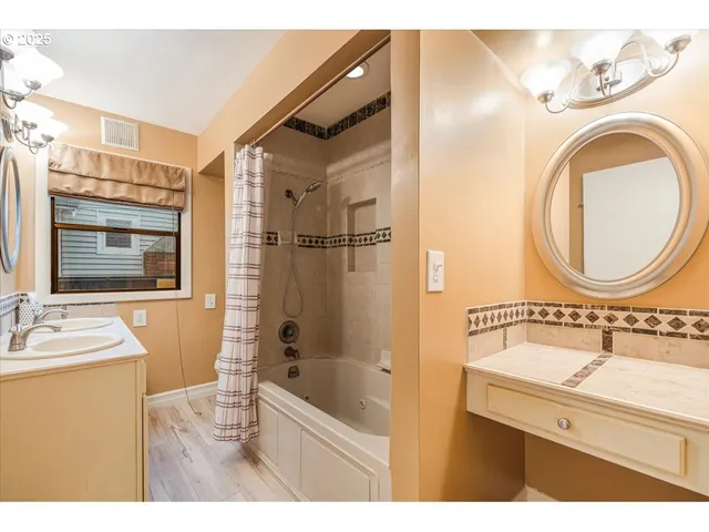 a bathroom with a sink a mirror and a shower