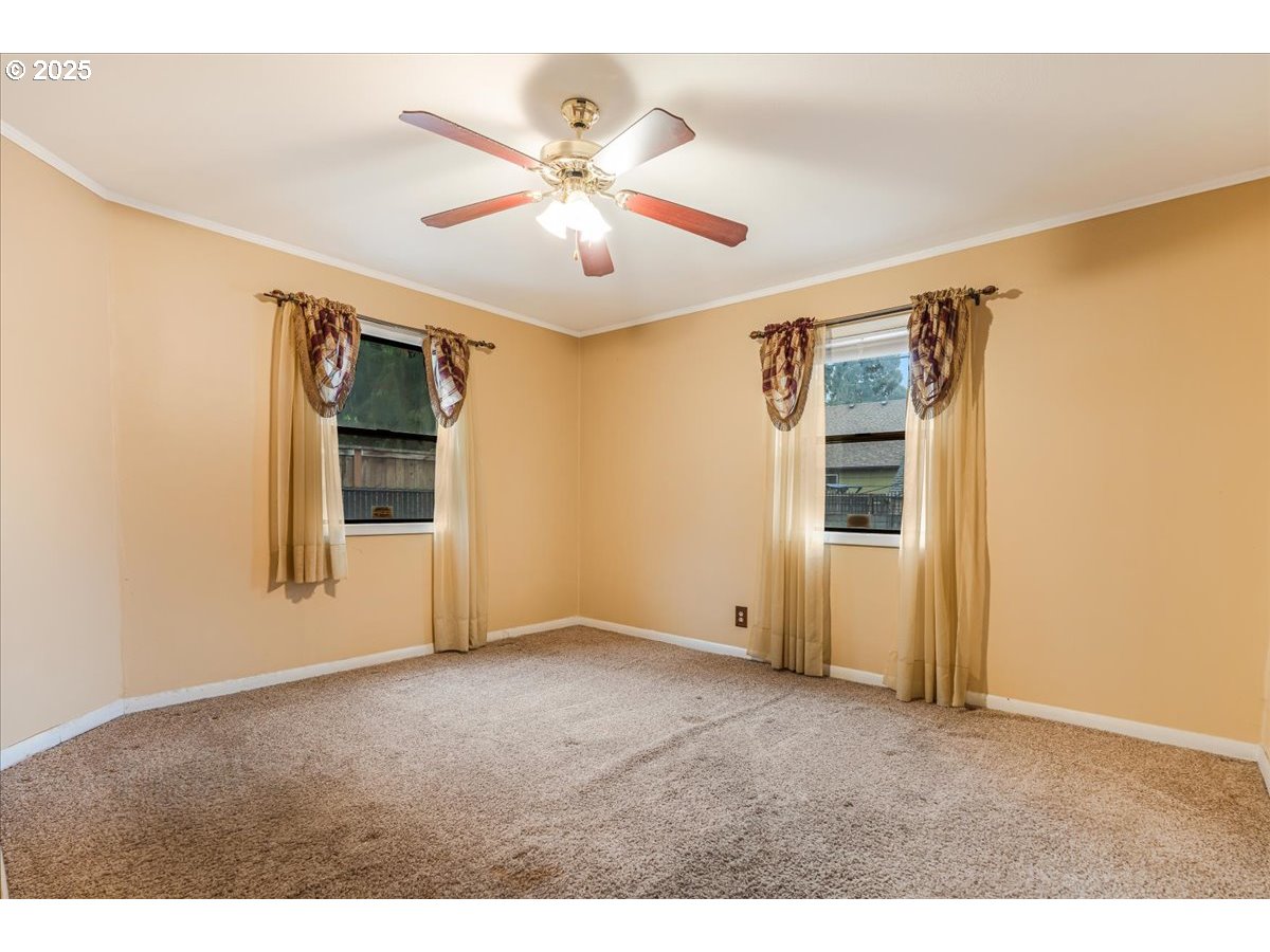 5925 Northeast 27th Avenue Portland, OR 97211 - Photo 13 of 25 a view of an empty room with window and chandelier fan