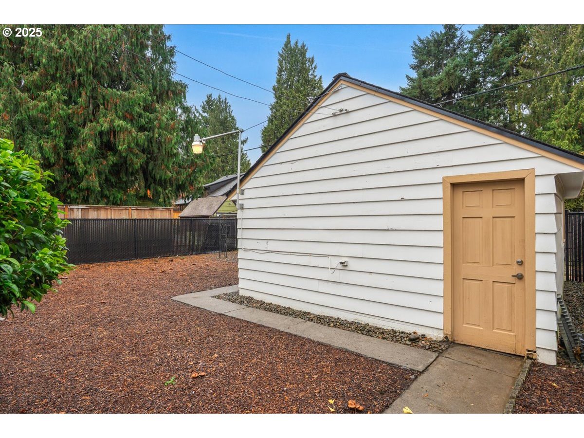 5925 Northeast 27th Avenue Portland, OR 97211 - Photo 22 of 25 a view of a white house with a yard