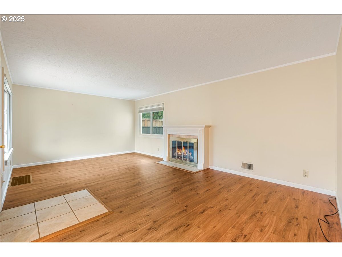5925 Northeast 27th Avenue Portland, OR 97211 - Photo 3 of 25 a view of an empty room with wooden floor and a window