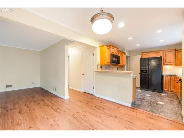 a view of a kitchen with a sink and a refrigerator