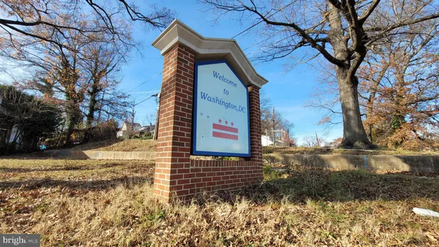 a pathway of a house next to a yard