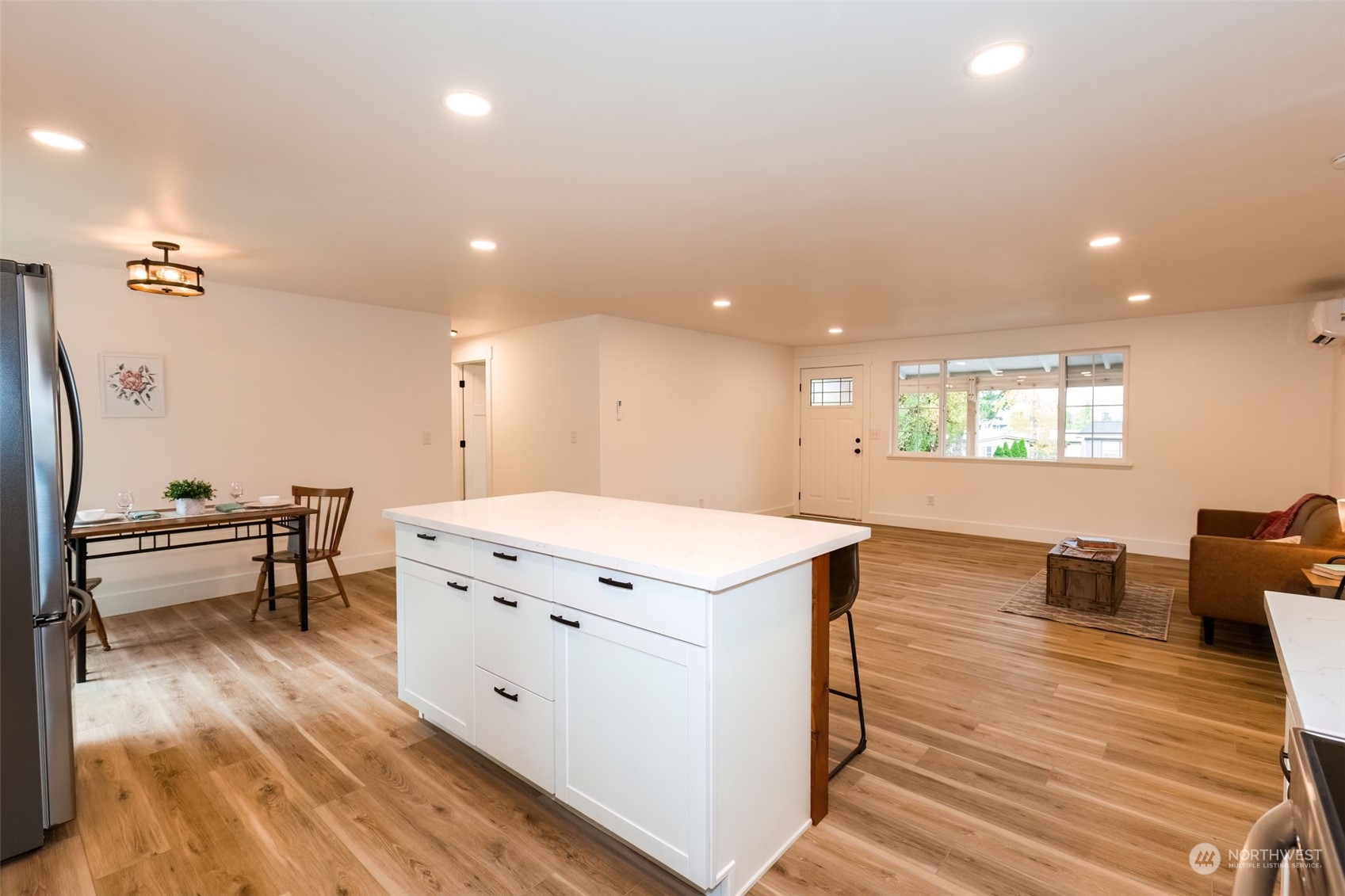 3719 Rhapsody Drive Southeast Port Orchard, WA 98366 - Photo 14 of 40 a kitchen that has a lot of cabinets a sink and a wooden floor in it