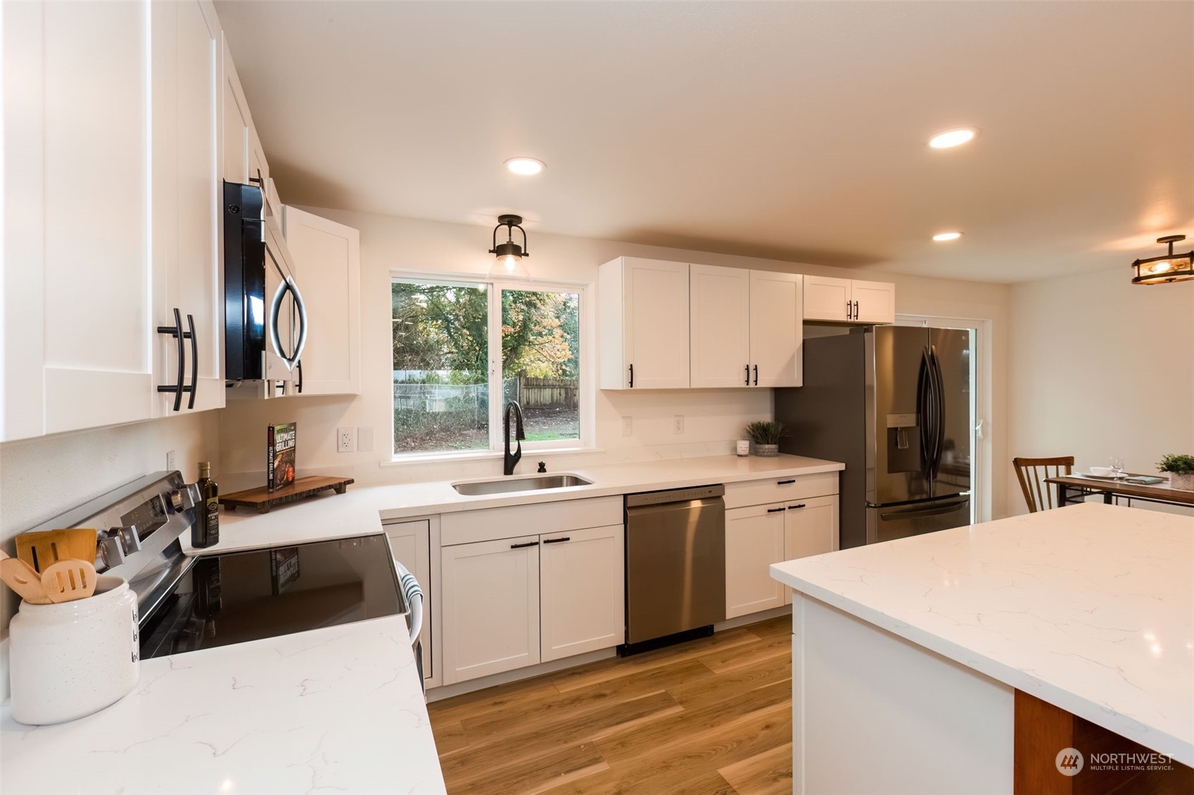 3719 Rhapsody Drive Southeast Port Orchard, WA 98366 - Photo 16 of 40 a kitchen with a sink a stove a refrigerator and cabinets