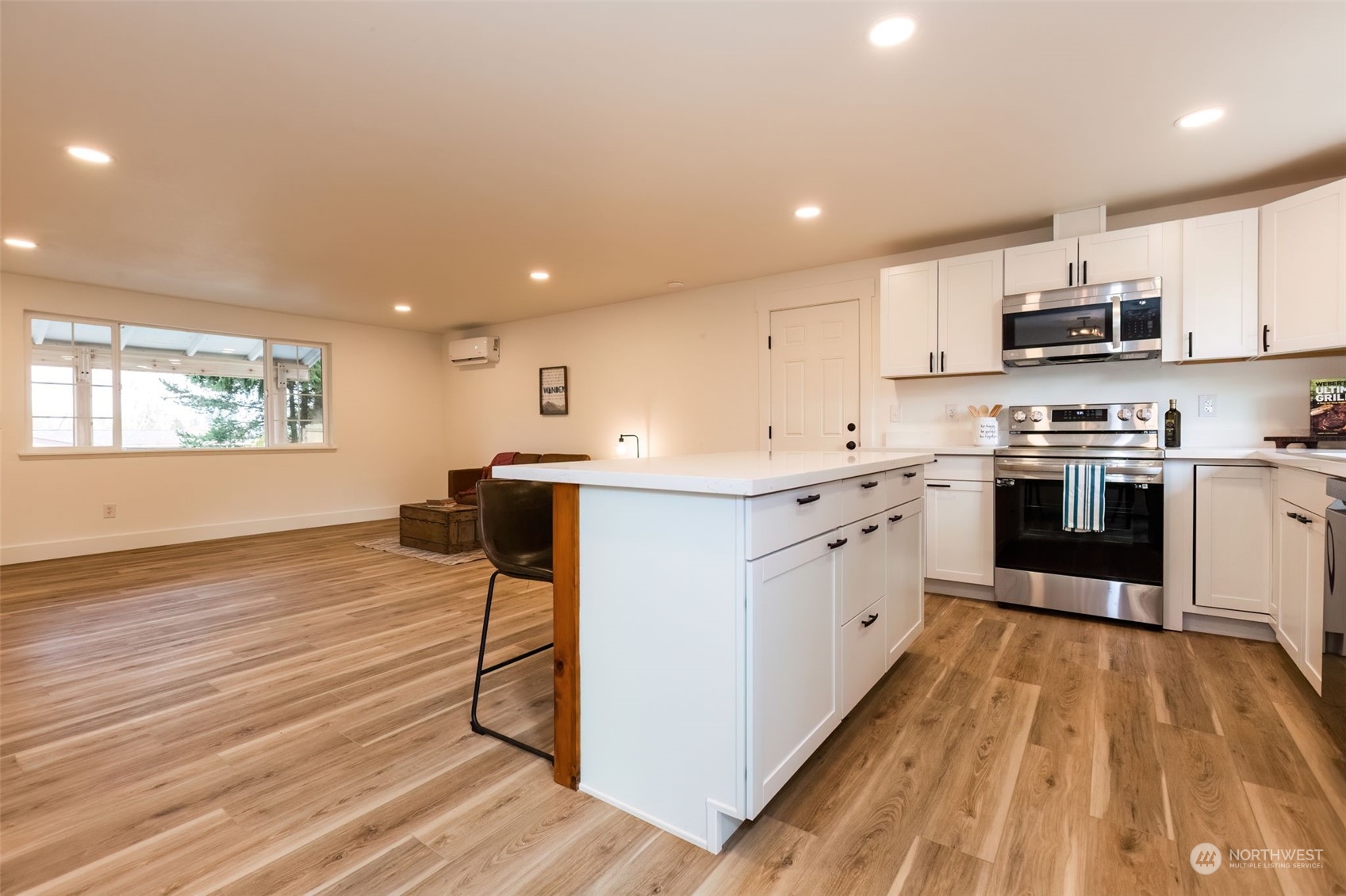 3719 Rhapsody Drive Southeast Port Orchard, WA 98366 - Photo 17 of 40 a large kitchen with stainless steel appliances granite countertop a stove a sink dishwasher and a oven with white cabinets