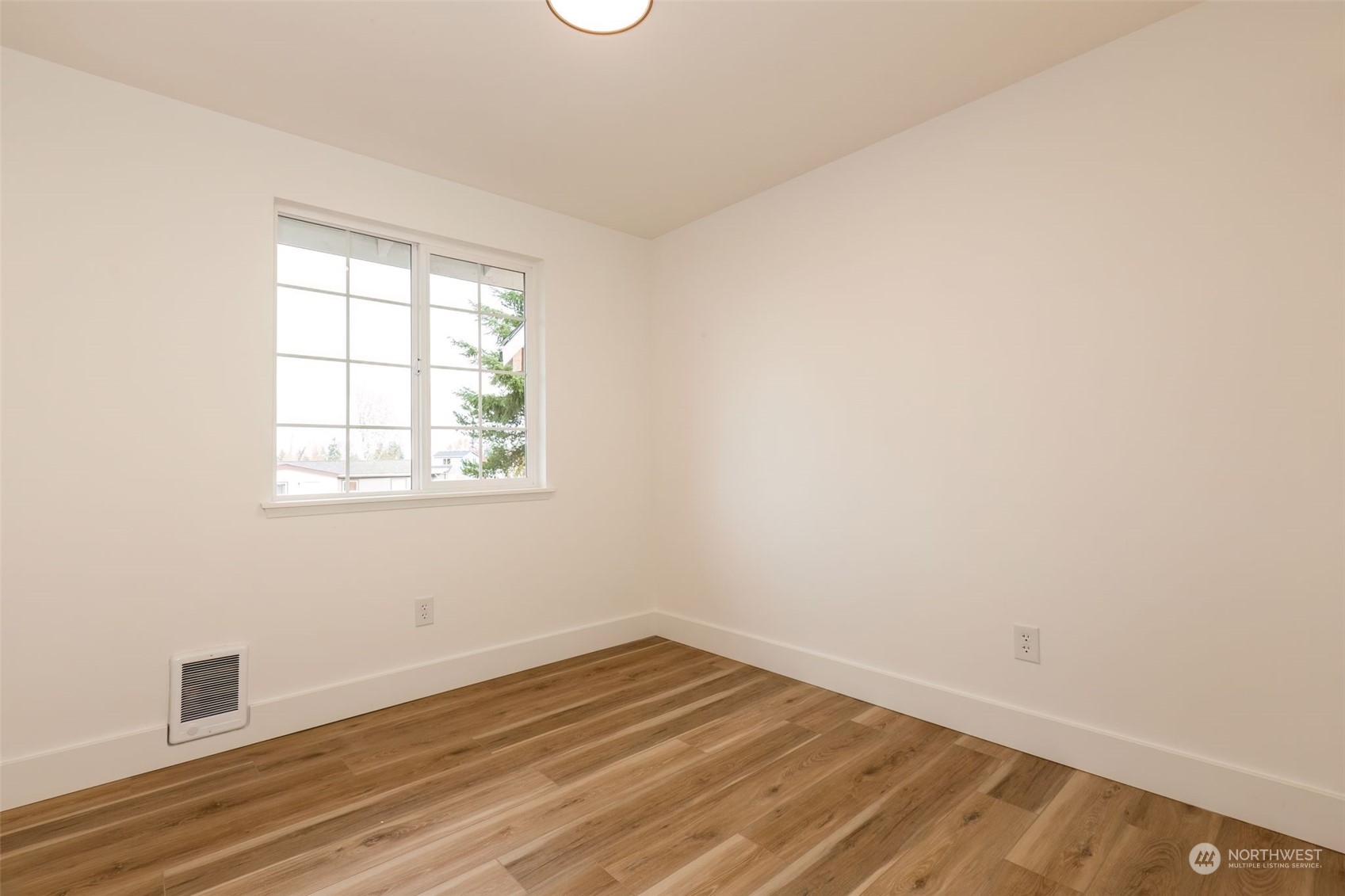 3719 Rhapsody Drive Southeast Port Orchard, WA 98366 - Photo 23 of 40 an empty room with wooden floor and windows