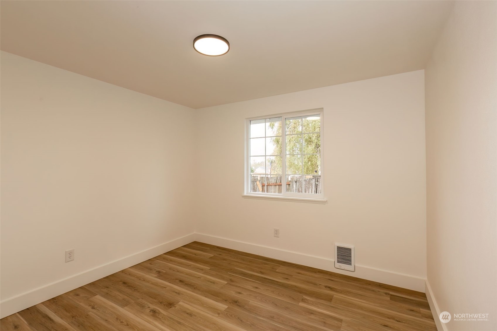 3719 Rhapsody Drive Southeast Port Orchard, WA 98366 - Photo 27 of 40 an empty room with wooden floor and windows