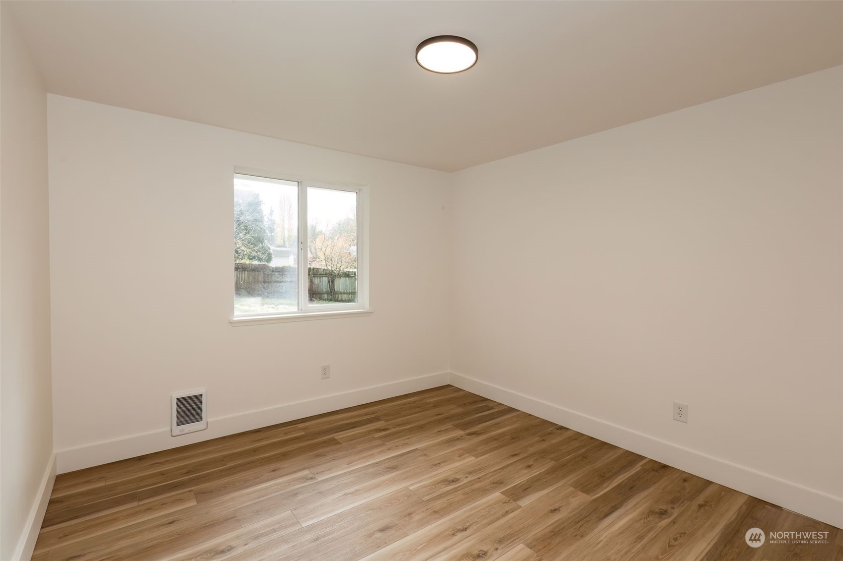 3719 Rhapsody Drive Southeast Port Orchard, WA 98366 - Photo 30 of 40 an empty room with wooden floor and windows