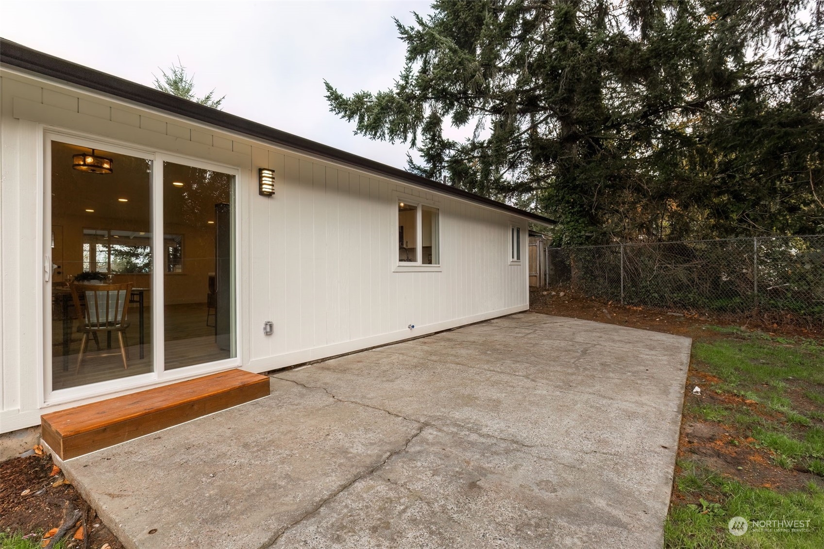3719 Rhapsody Drive Southeast Port Orchard, WA 98366 - Photo 37 of 40 a backyard of a house with large trees