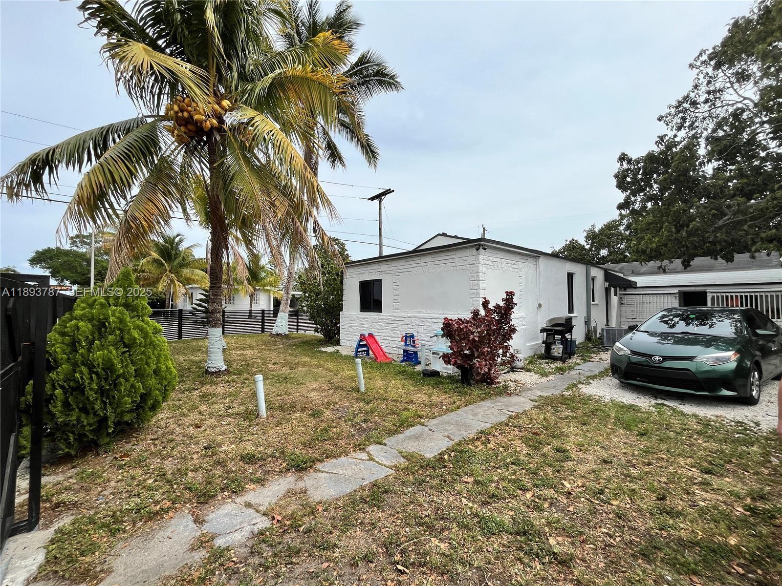 1102 Northwest 103rd Street Miami, FL 33150 - Photo 30 of 37 a view of a house with a patio