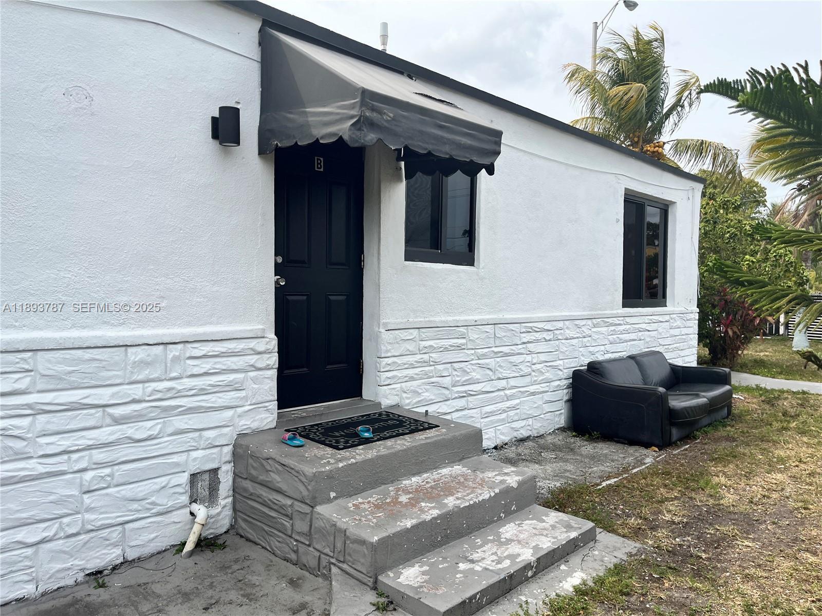 1102 Northwest 103rd Street Miami, FL 33150 - Photo 35 of 37 a front view of a house with a window