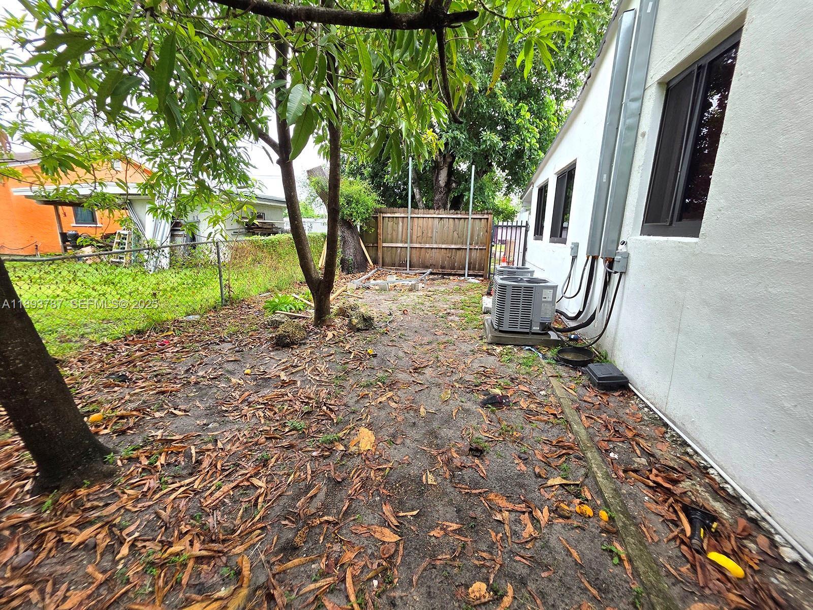 1102 Northwest 103rd Street Miami, FL 33150 - Photo 37 of 37 a backyard of a house with lots of green space