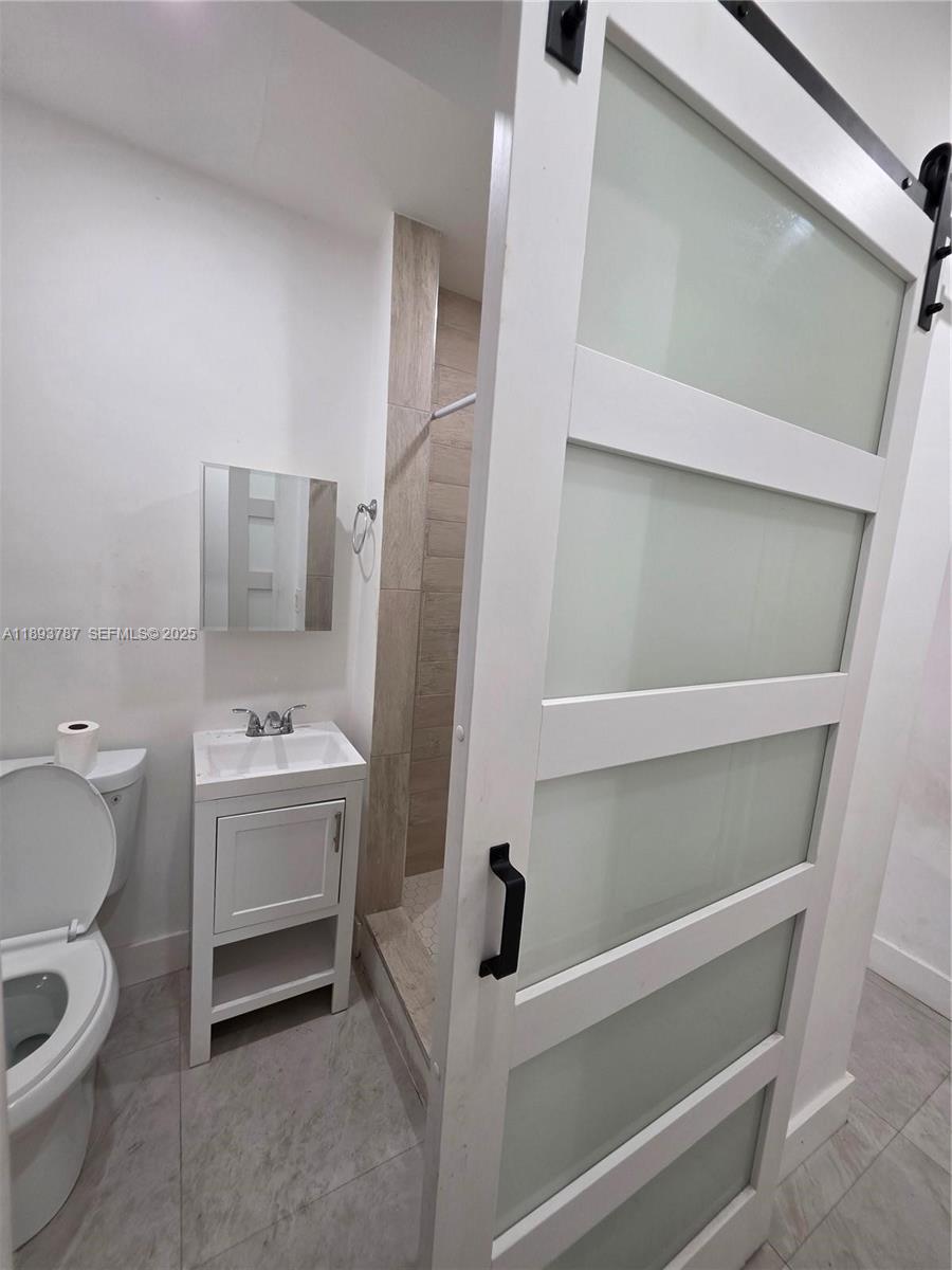 1102 Northwest 103rd Street Miami, FL 33150 - Photo 5 of 37 a bathroom with a sink toilet and tub