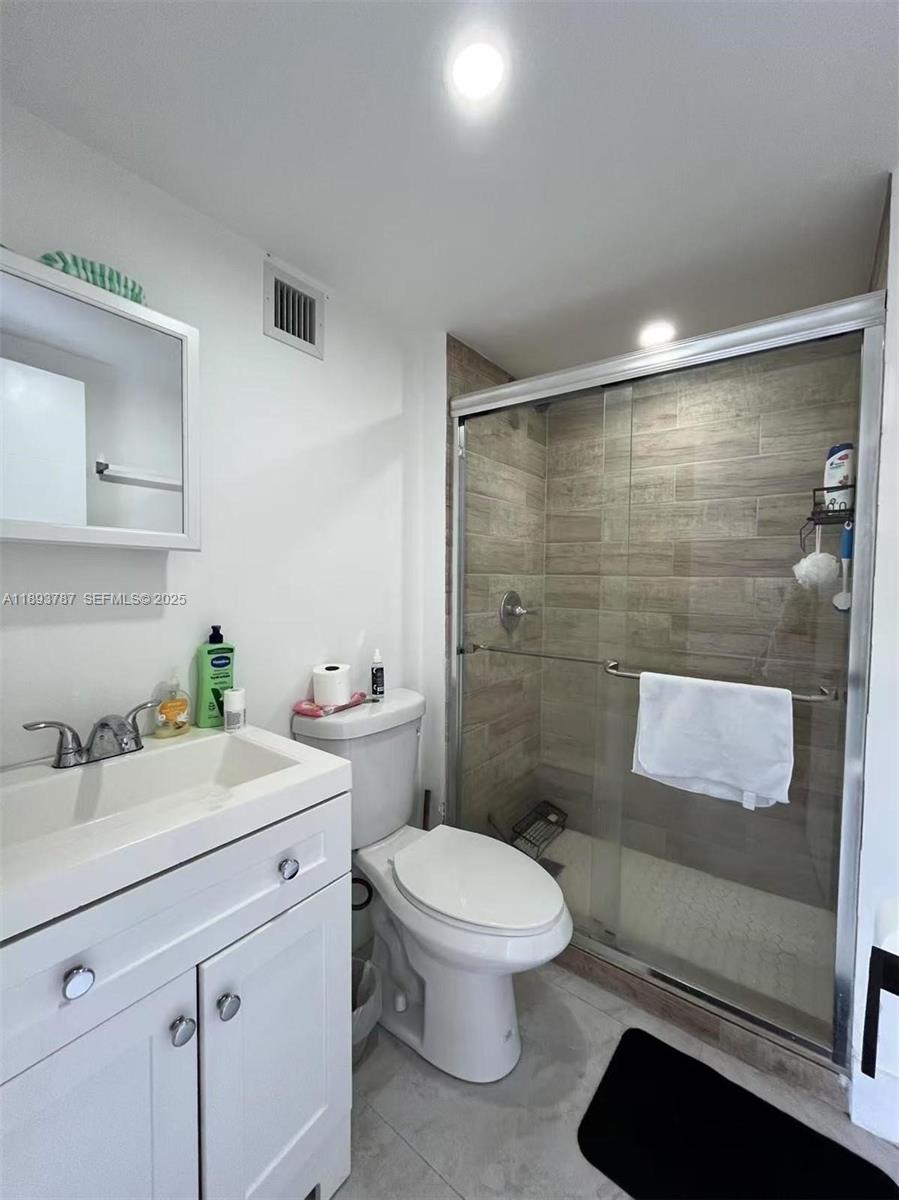 1102 Northwest 103rd Street Miami, FL 33150 - Photo 6 of 37 a bathroom with a sink a toilet and shower
