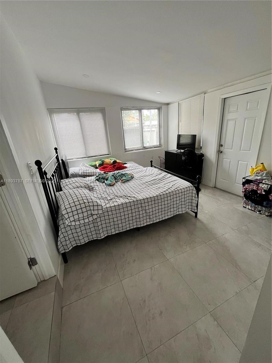 1102 Northwest 103rd Street Miami, FL 33150 - Photo 9 of 37 a bedroom with bed and window
