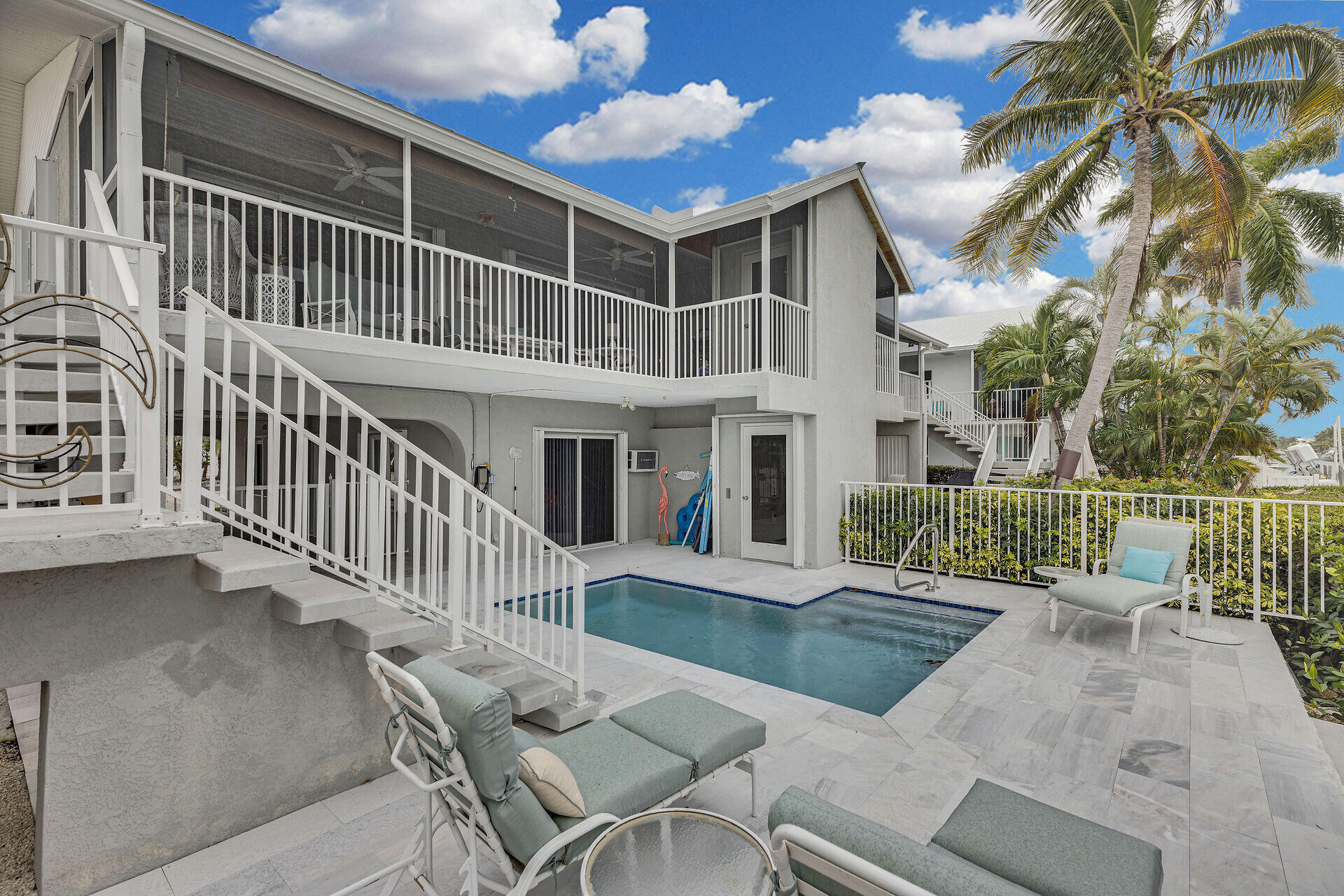 a view of a house with backyard porch and sitting area