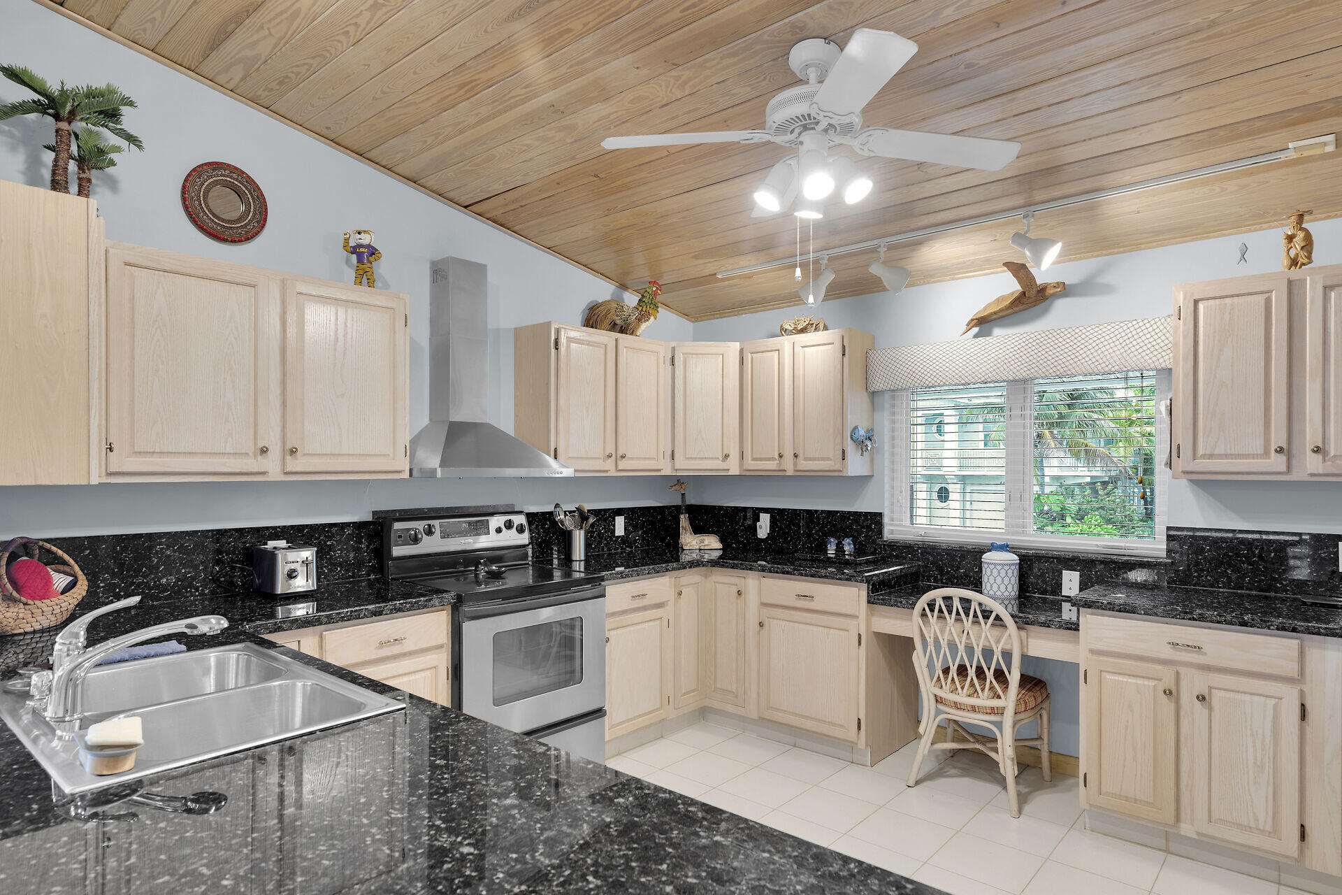 651 9th Street Key Colony Beach, FL 33051 - Photo 20 of 53 a kitchen with granite countertop a sink a stove and cabinets