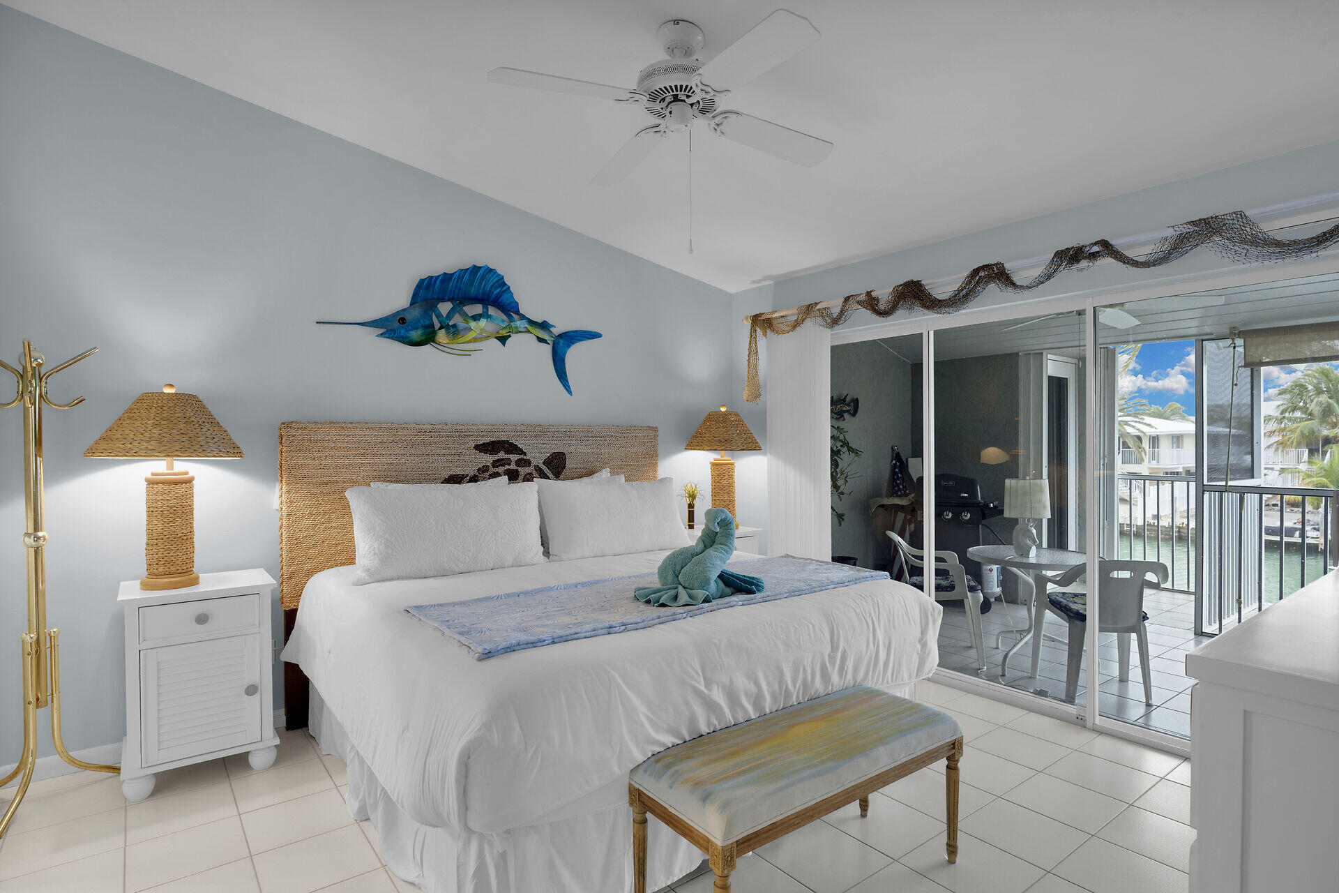 651 9th Street Key Colony Beach, FL 33051 - Photo 23 of 53 a bedroom with a bed mirror and painting on the wall