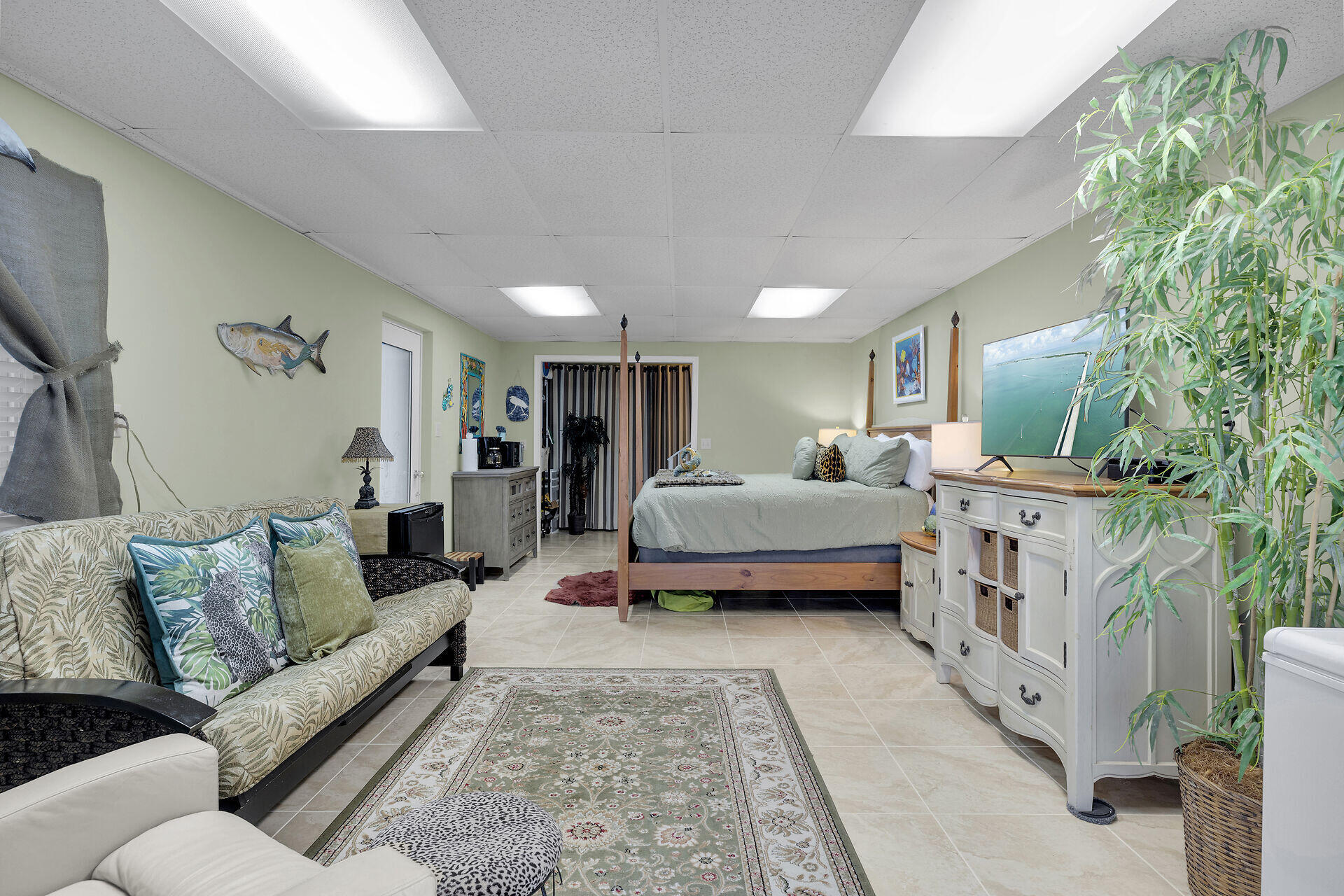 651 9th Street Key Colony Beach, FL 33051 - Photo 34 of 53 a spacious bedroom with a bed a couch and dresser