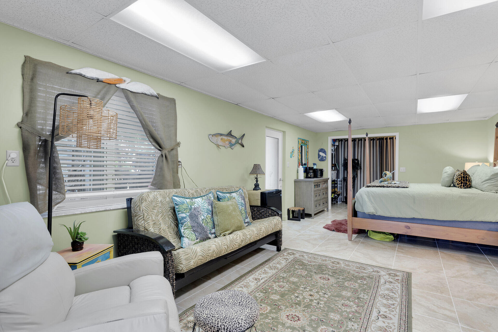 651 9th Street Key Colony Beach, FL 33051 - Photo 35 of 53 a spacious bedroom with a bed a couch and large window