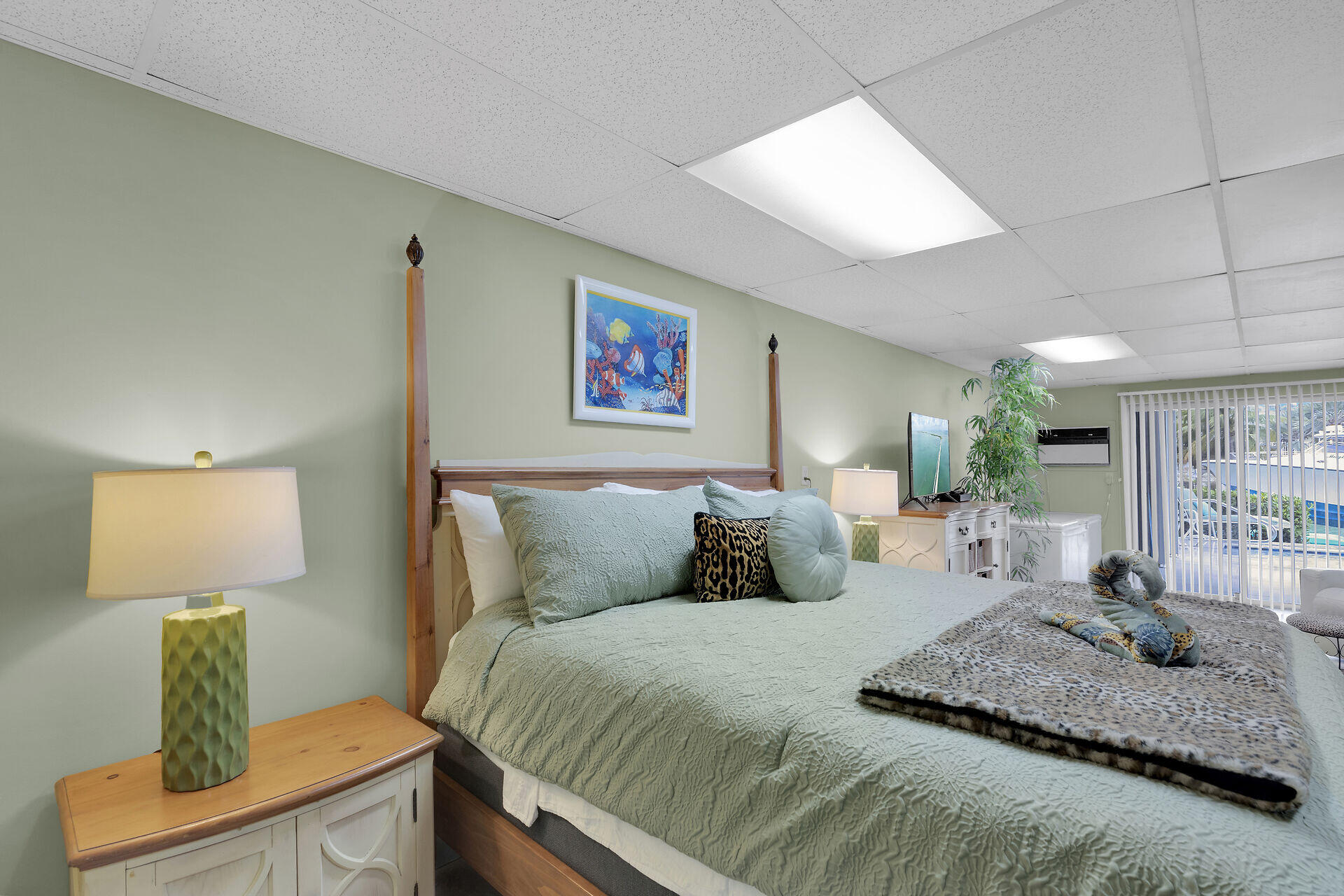 651 9th Street Key Colony Beach, FL 33051 - Photo 37 of 53 a bedroom with a large bed and a lamp on dresser