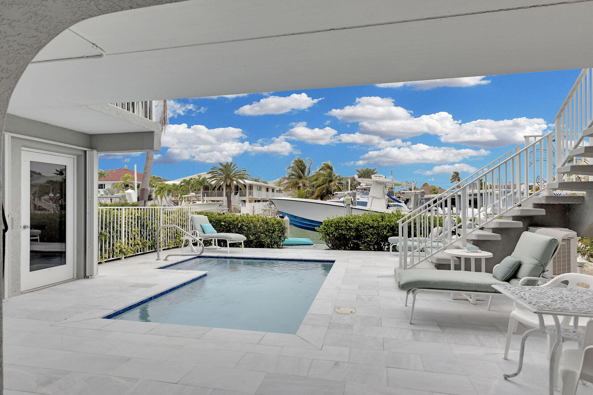 651 9th Street Key Colony Beach, FL 33051 - Photo 5 of 53 a view of a patio with couches and a floor to ceiling window