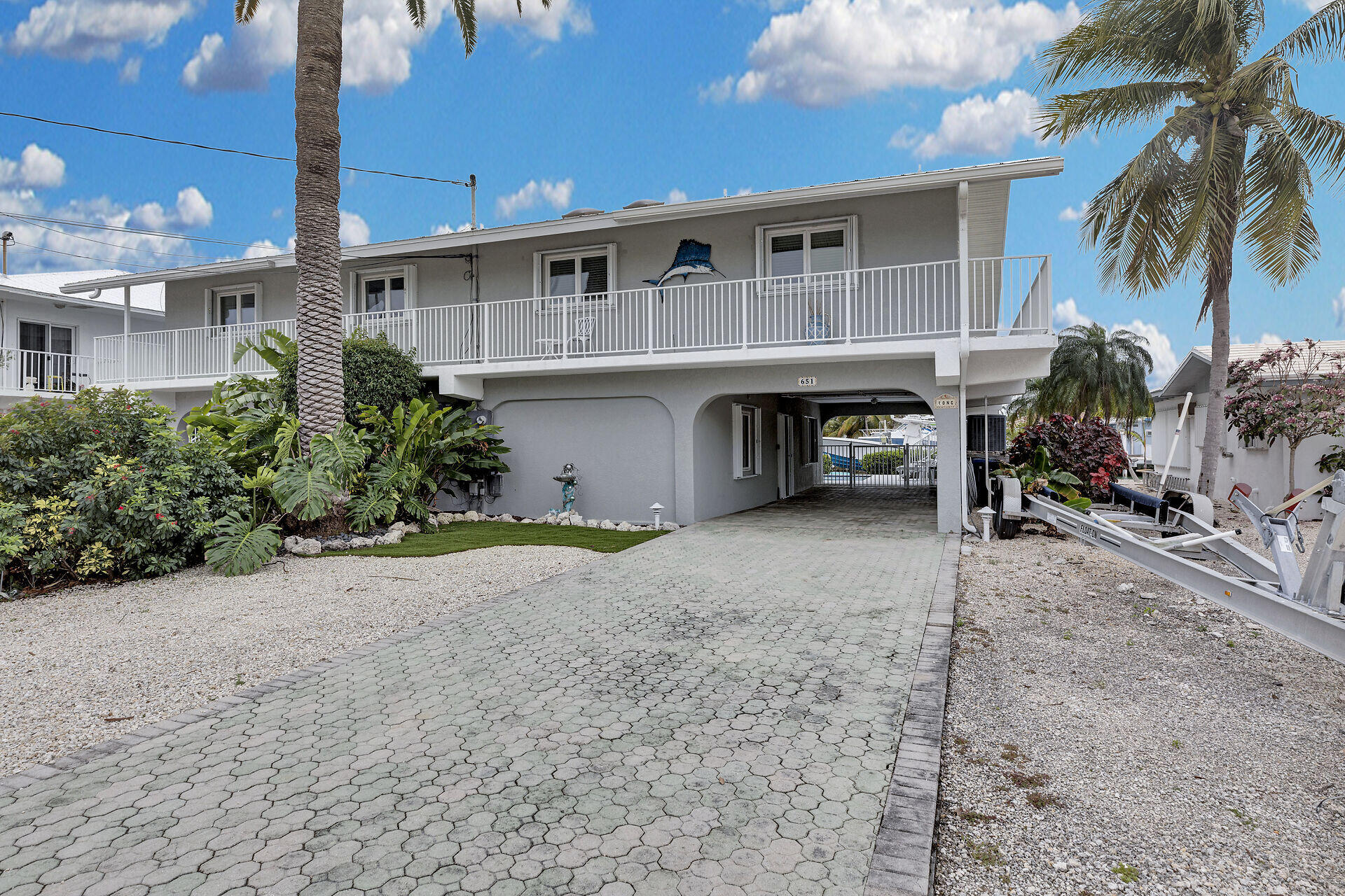 651 9th Street Key Colony Beach, FL 33051 - Photo 8 of 53 a front view of a house with a yard and garage