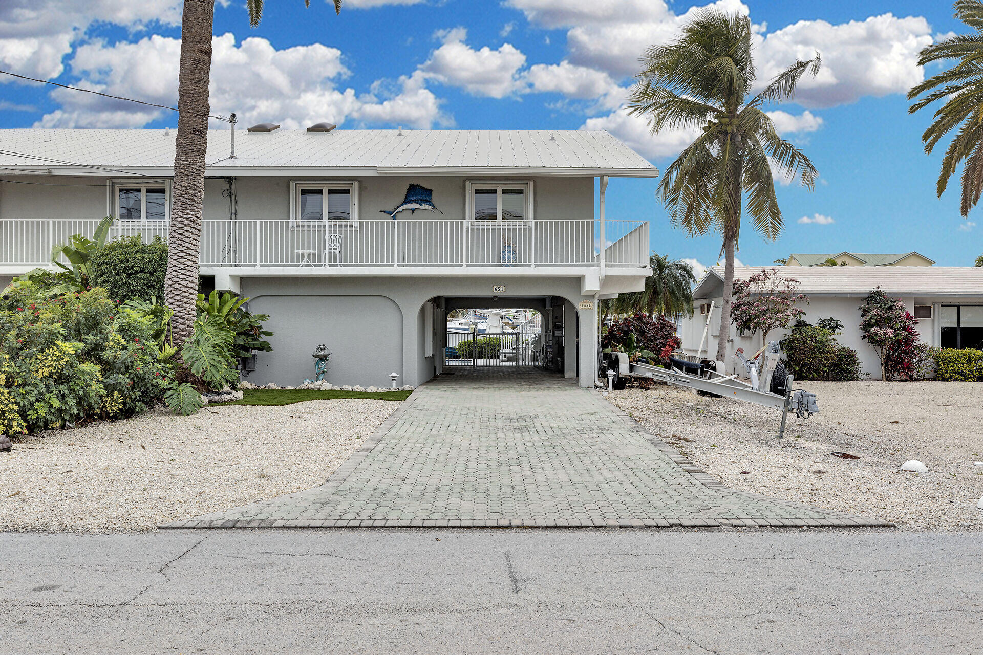 651 9th Street Key Colony Beach, FL 33051 - Photo 9 of 53 a view of a house with a yard and potted plants
